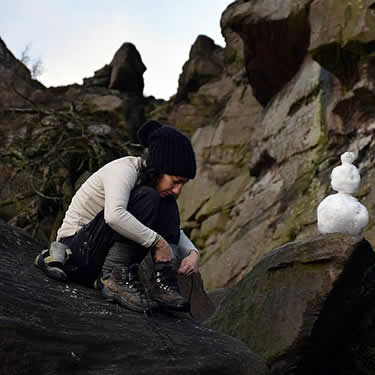 A quick break from climbing to sit with a tiny snowman!