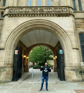 Chinmay in front of the University of Manchester building