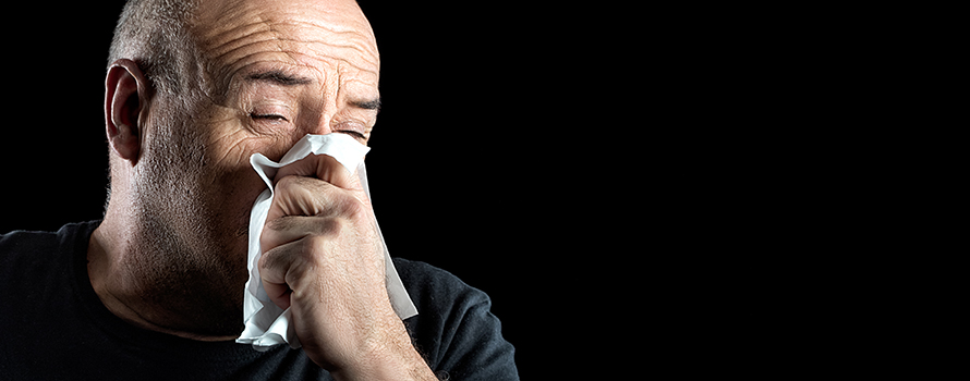 The transmission of influenza illustrated by a person sneezing