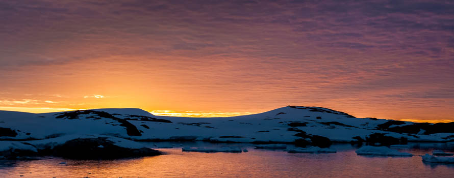 A photograph of the antarctic coast at sunset