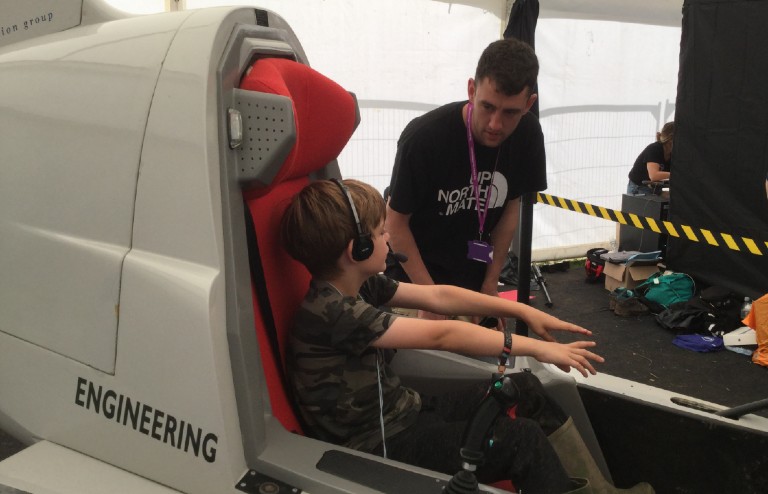 John Gavaghan operating the flight sim at Bluedot Festival