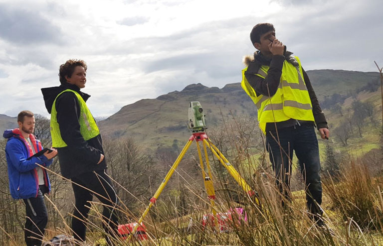 Civil engineering students taking measurements on a field trip to Patterdale, Cumbria
