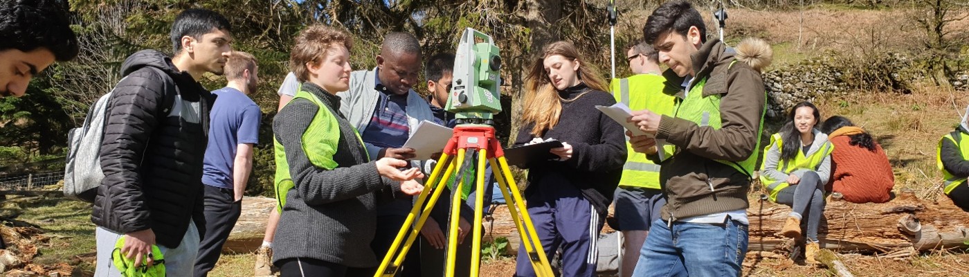 Civil engineering students taking measurements on a field trip to Patterdale, Cumbria