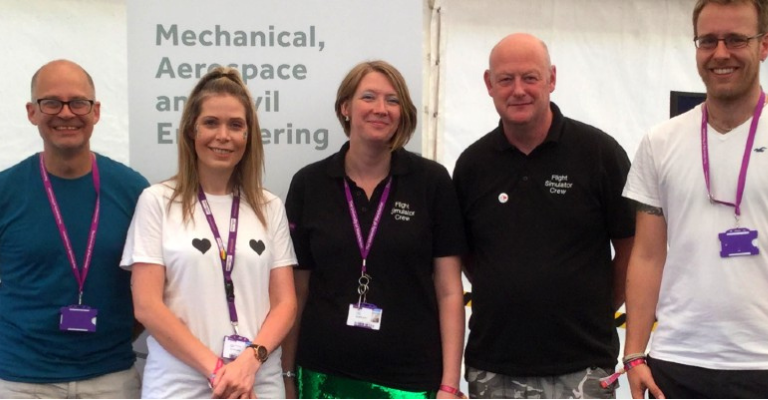 Natalie stands in the middle of the photo taken at Bluedot festival, with 1 woman and 3 men from the engineering department