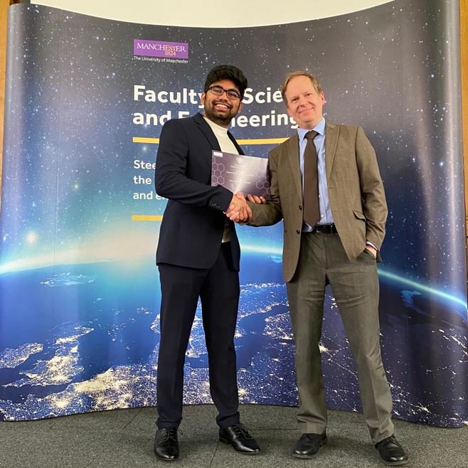 A proud moment: Chaitanya stands on stage, receiving his scholarship certificate form Professor Peter Green. 