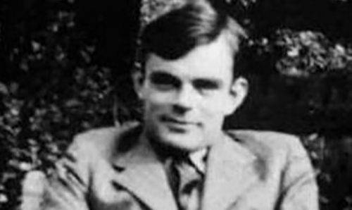 Alan Turing smiling at the camera