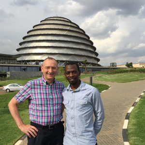 Professor Andy Gale, Deputy Head of School (Social Responsibility) for the University’s School of Mechanical, Aerospace and Civil Engineering, and Harouna Nshimiyimana, a Manchester graduate who is now Housing Regulations and Standards Division Manager at the Rwanda Housing Authority. They are standing in front of the new Kigali Convention Centre, which is shaped in the form of a traditional Rwandan domestic dwelling. 