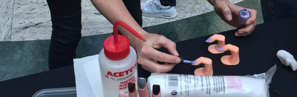 Painting nails at the Nailed It! stand at ScienceX