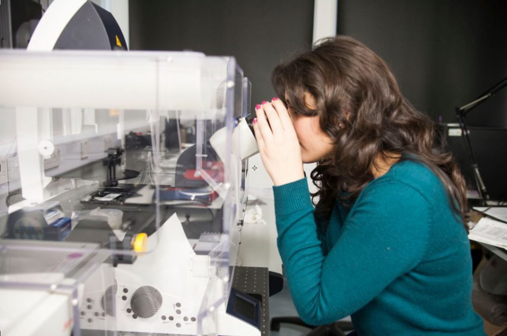 Scientist looking in microscope