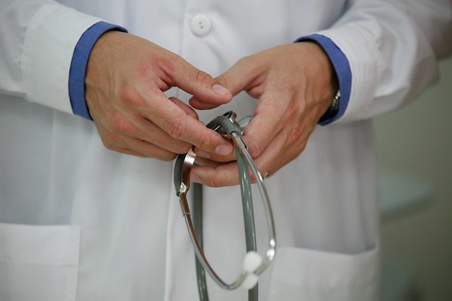Doctor's hands holding stethoscope