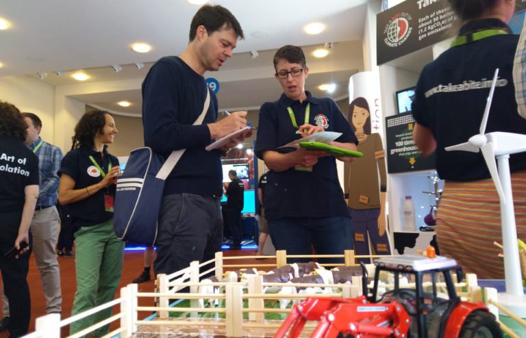 men looking at science display