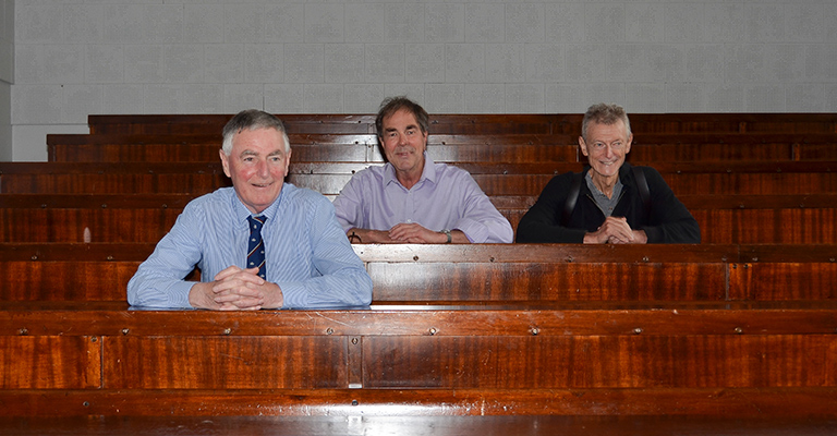 The three men in a lecture theatre