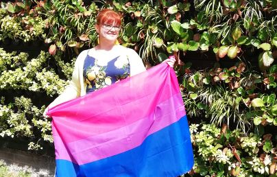 Woman holding bi flag