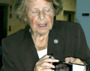 Dame Kathleen Ollerenshaw signing a book