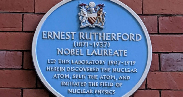 Blue plaque outside the Rutherford Building at The University of Manchester.