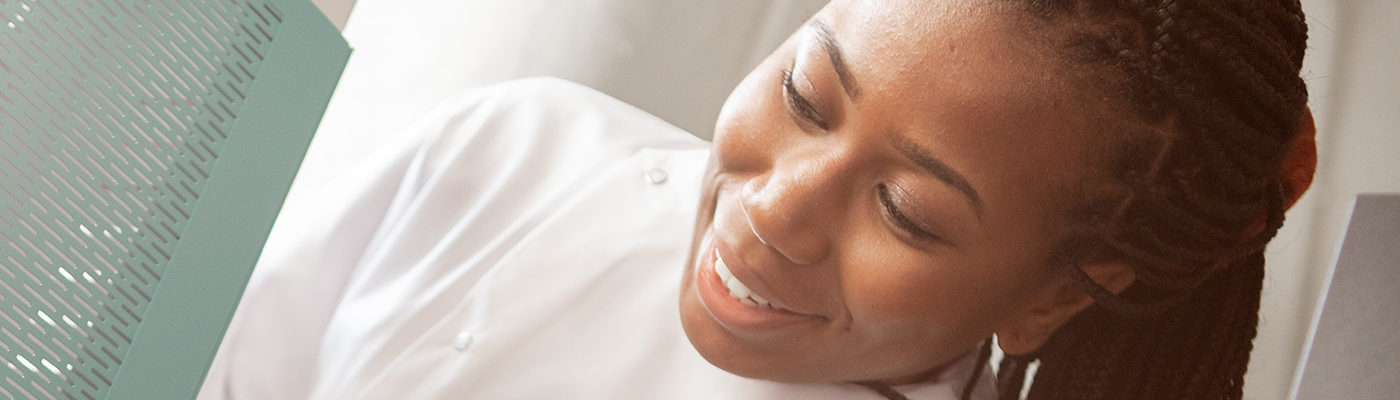 A Black woman scientist in lab coat