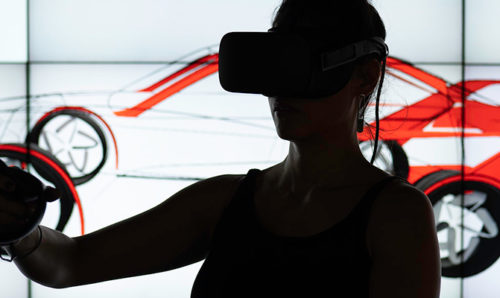 Woman using virtual reality to design a car