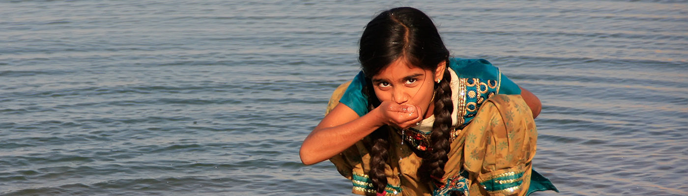 Girl drinking water in India