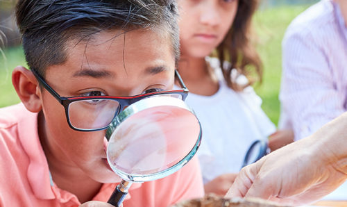 Children using a magnifying glass