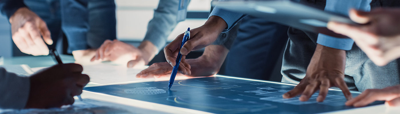 Engineers' hands with pens