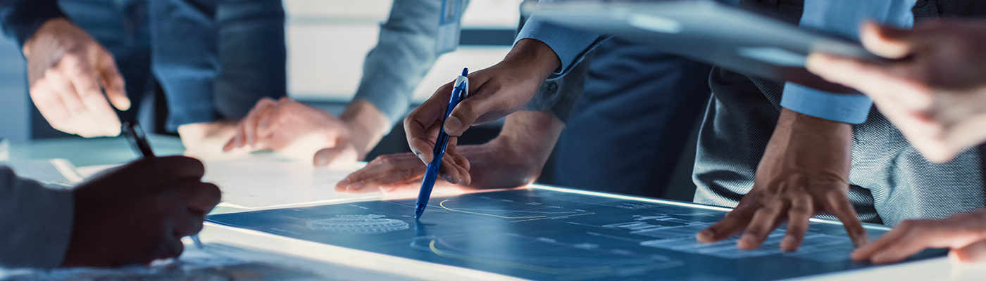 Engineers' hands with pens