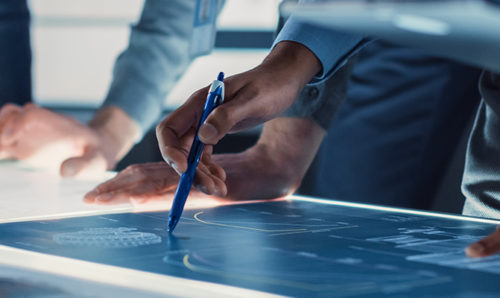 Engineers' hands with pens