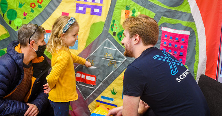 Adult volunteer talks to child