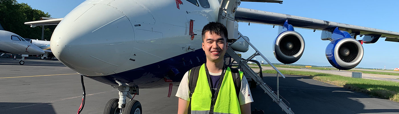 Chenjie Yu in front of an aeroplane