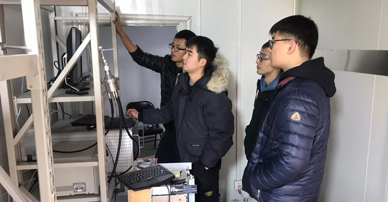 Chenjie Yu and team at a computer