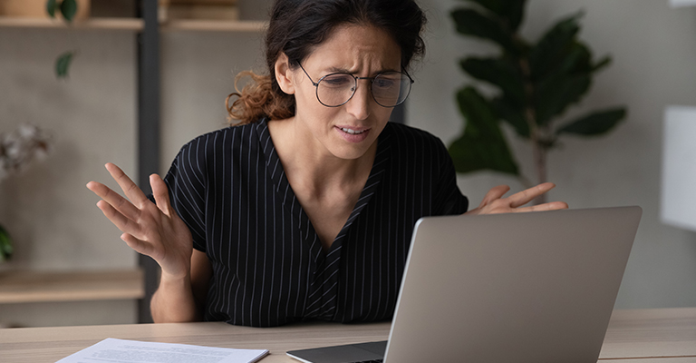 Woman looking puzzled at her laptop