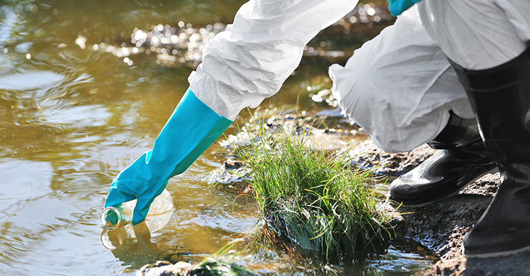 Scientist collecting water from a lake