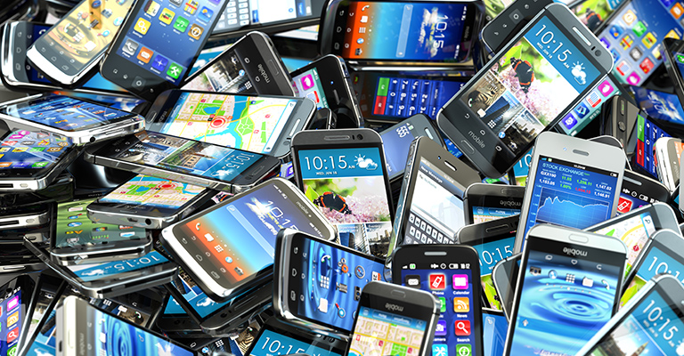 A pile of broken mobile phones