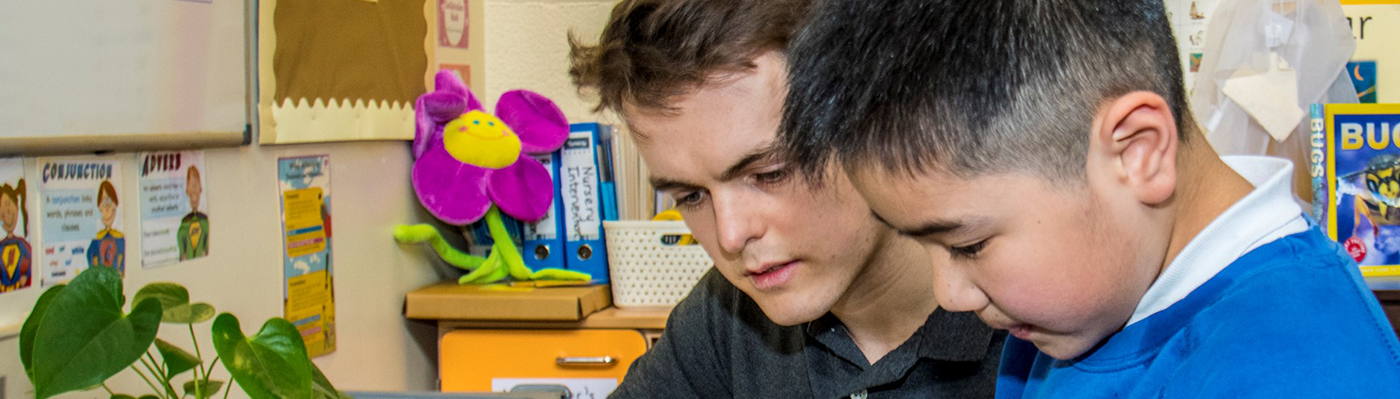 Scientist and school pupil working together