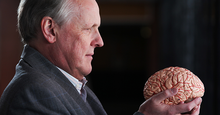 Professor Steve Furber holding a model brain