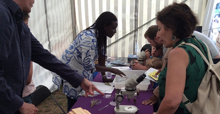 Dr Cecilia Medupin speaking to people at a science fair.