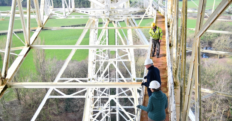Engineers walk down the central walkway of the Lovell Telescope.