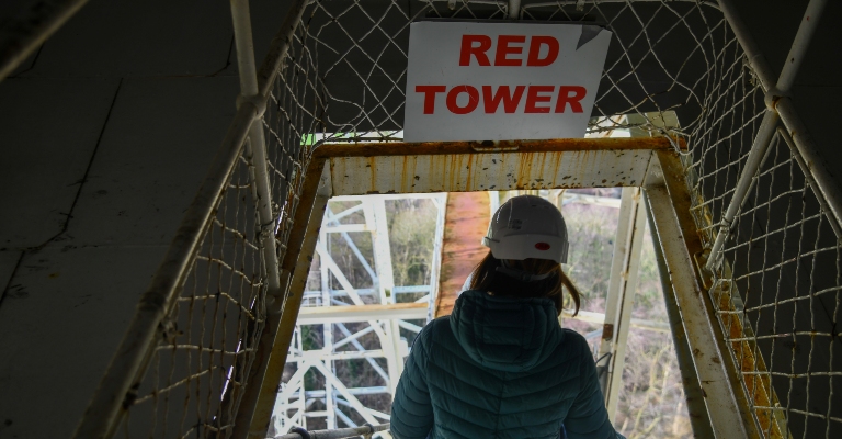 An engineer walks down the steps from the Red Tower within the Lovell Telescope.