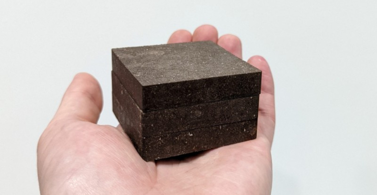 A hand holds blocks of StarCrete.