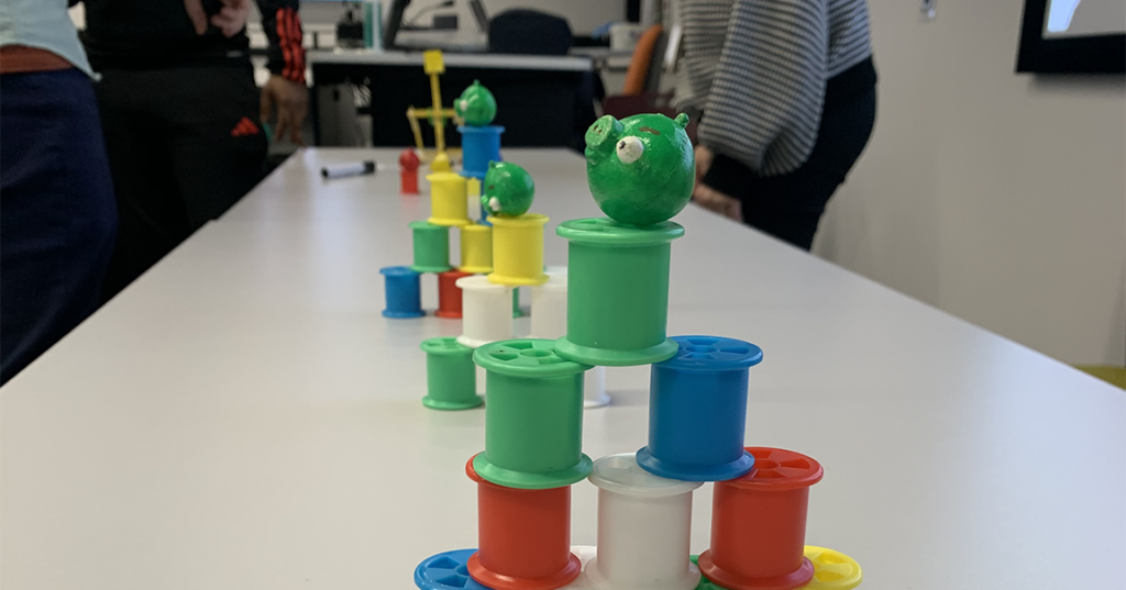 Angry birds catapult aimed at plastic spools 