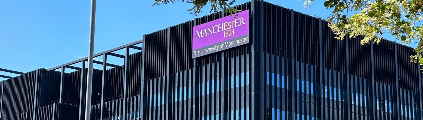 A photo of Engineering building A, flanked by trees and a blue sky.