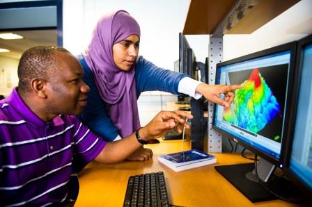 Two students discussing computer modelling imagery