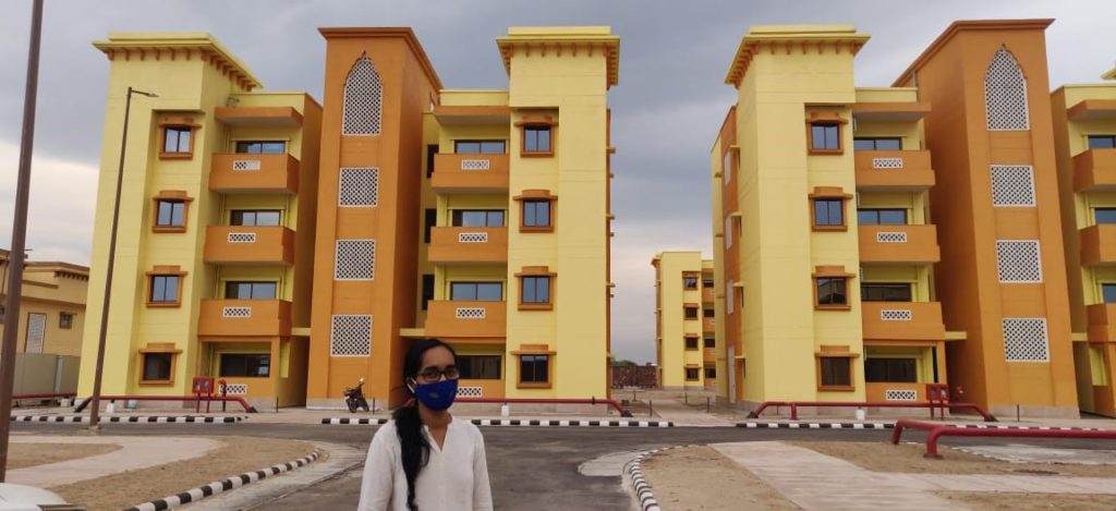 A picture of Sanya in front of buildings during a field visit during the internship at the RRP CISF Township 