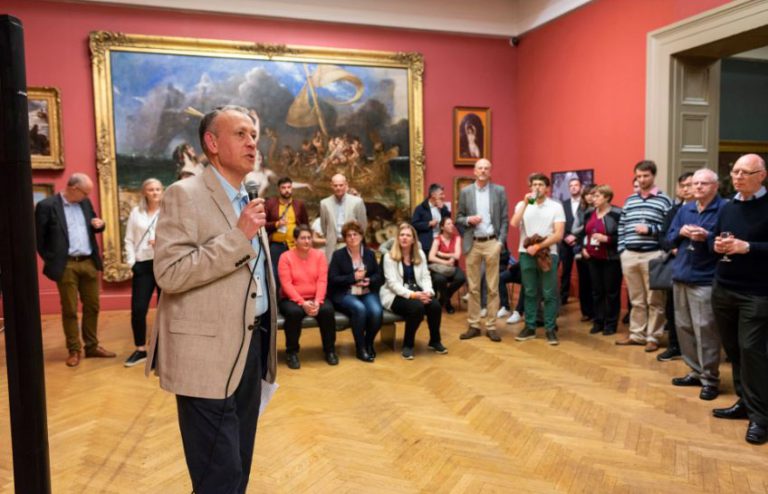 symposium speaker in art gallery