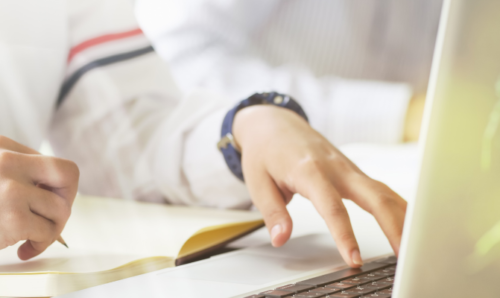 Student with laptop and book