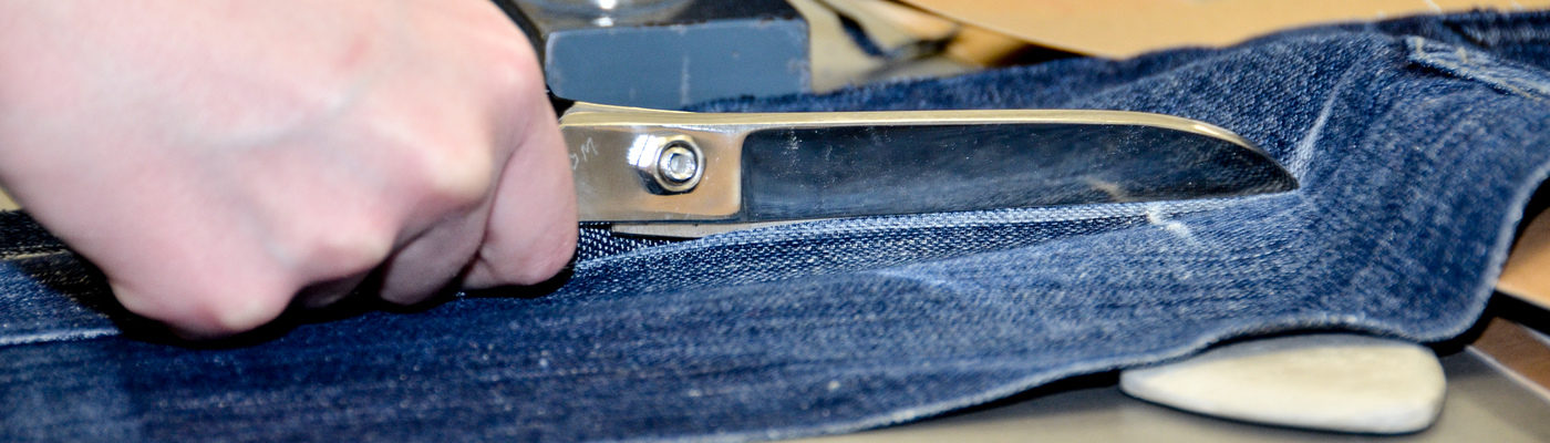 Scissors cutting denim